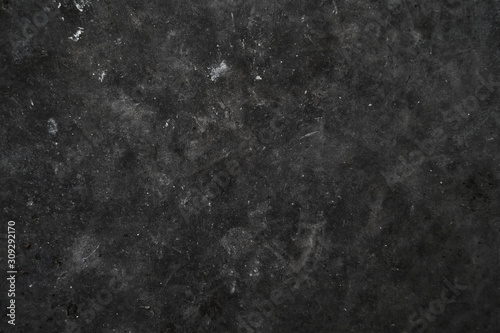 Dark rough texture of an untreated concrete wall