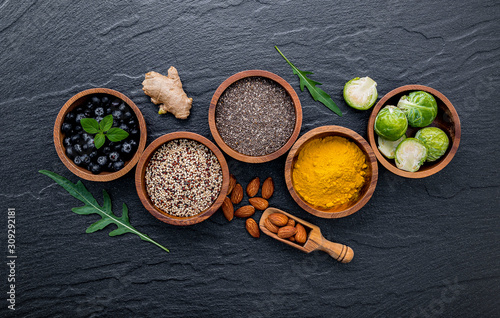 Super foods on in wooden bowl. Selection food and healthy food set up on dark stone background.