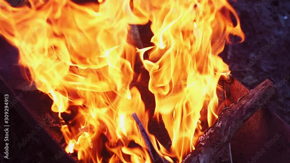 In the evening firewood burns in a charcoal grill. In the evening firewood burns in a charcoal grill.