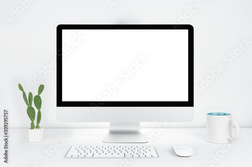 Computer with blank white copy space for text, Mockup design desktop computer in office on white table with keyboard and Coffee cub, Work place concept, Cactus in pot.