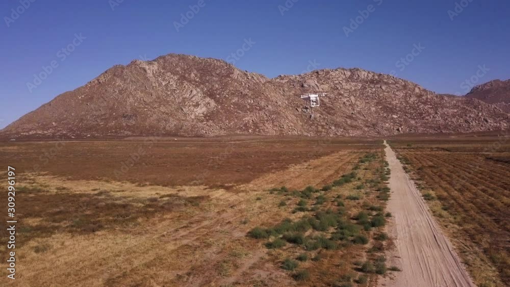 Drone carrying bait in the desert. Bird training using modern technology concept Drone carrying bait in the desert. Bird training using modern technology concept