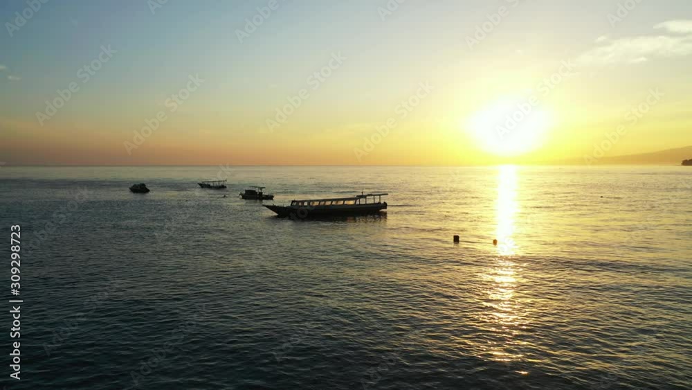 Idyllic tropical landscape with sunset sky, open ocean and fisherman boats Idyllic tropical landscape with sunset sky, open ocean and fisherman boats
