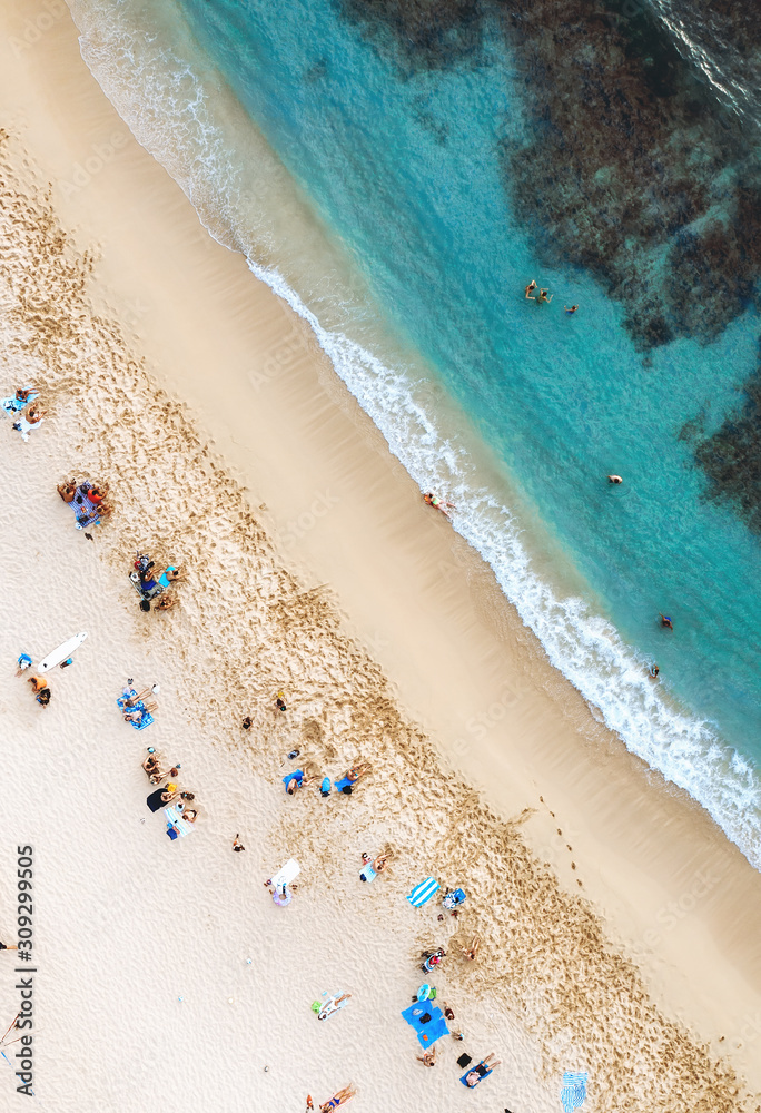 Aerial drone landscape of Waikiki beach, Honolulu, Oahu, Hawaii. Ocean and peoples at famous paradise beach shot from above.