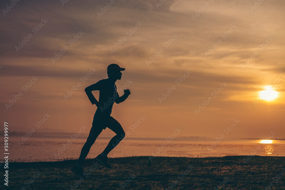 The man with runner on the  be running for exercise.Fit runner fitness runner during outdoor workout with sunset background
