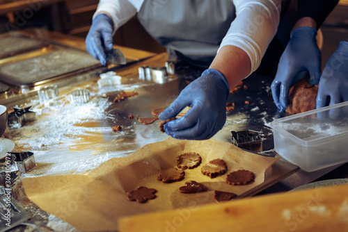 Making of Christmas gingerbread cookies in the restaurant. High ISO shallow depth of field image)