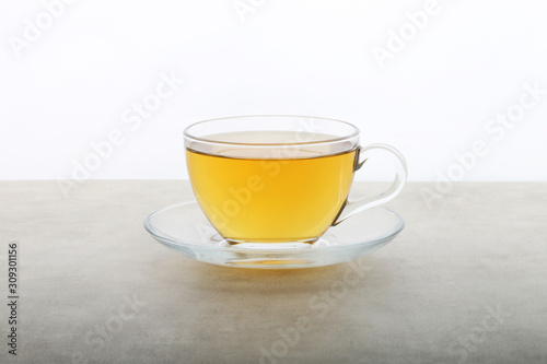Green Tea Cup - Herbal tea anise ginger and lemon on a white texture background - white table