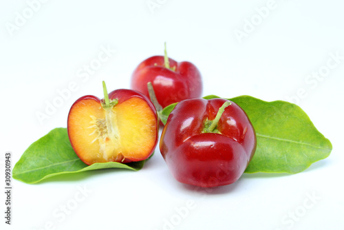Fresh acerola fruit and slice isolated on white