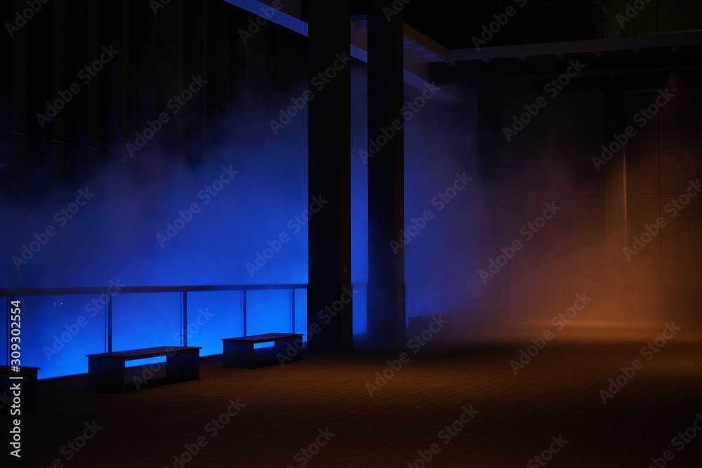 Dark empty room scene background with mysterious fog, smoke, spotlight and neon light.