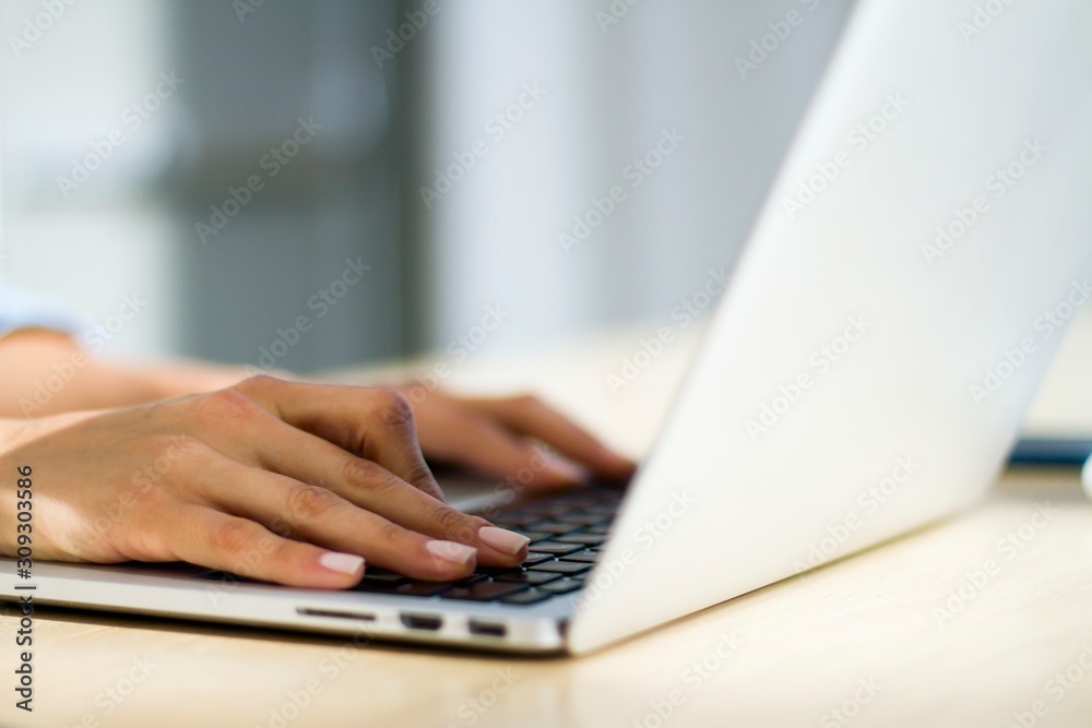 Woman hands typing on a laptop, working concept Woman hands typing on a laptop, working concept