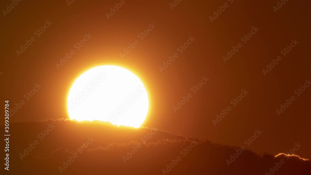 Beautiful nature video time lapse landscape. Big sun close-up rising at mountain.