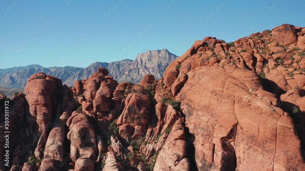 Aerial descending shot of Red Rock Canyon mountains, colorful sandstone cliffs