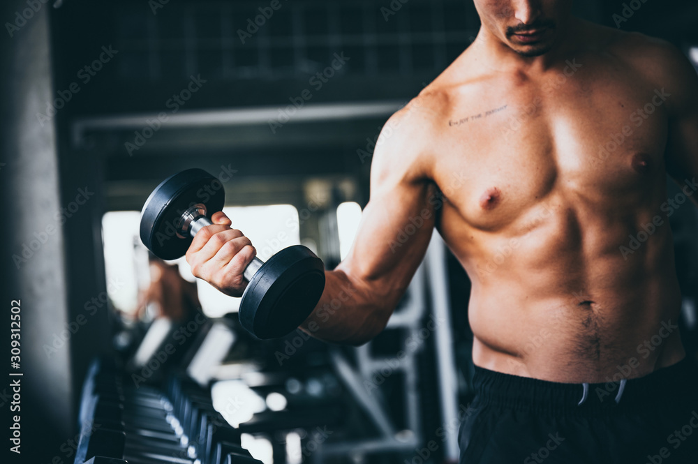 Strong man exercising in the sport gym
