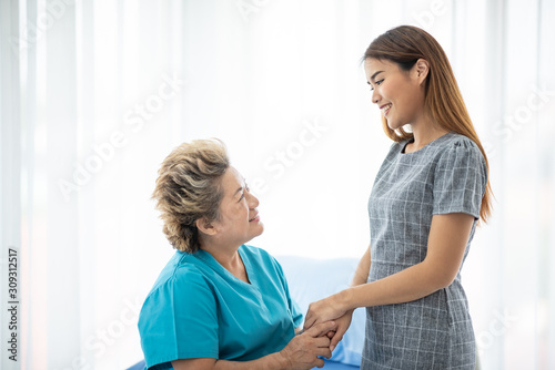 Wallpaper Mural Smiling and talking, caregiver smiling and talking to aged woman while taking care of her Torontodigital.ca