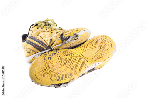 old dirty yellow  football shoes damaged on white background football  object isolated