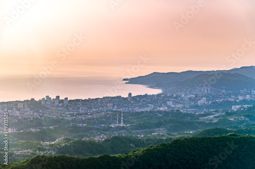 Layers of mountains and the sea in a haze in the light of the sunshine. View from Mount Akhun, Sochi, Russia.