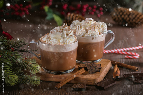 Hot chocolate with whipped cream and cinnamon sticks