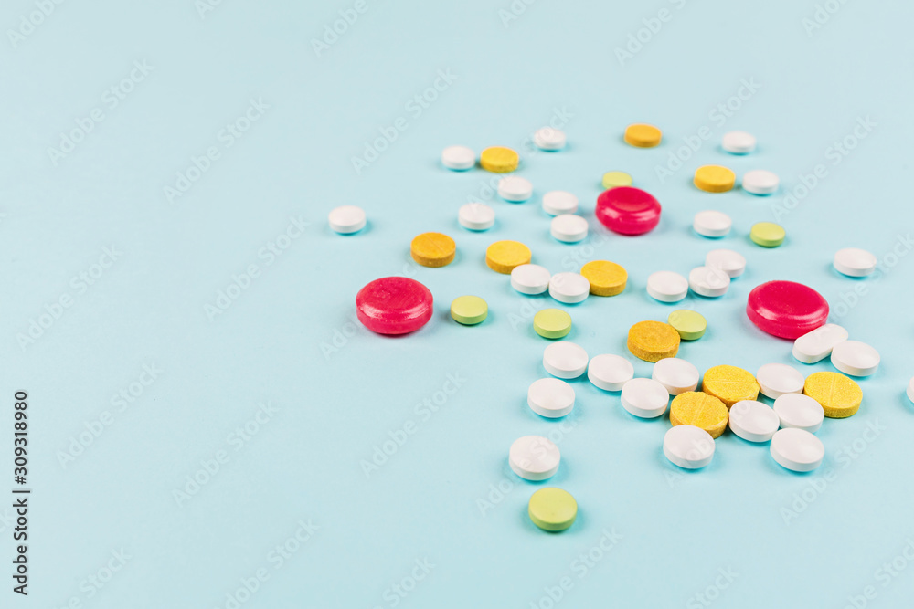 Colorful pills on a pastel blue background. Flat lay, top view, overhead, mockup, template. Pharmacy and medical concept Colorful pills on a pastel blue background. Flat lay, top view, overhead, mockup, template. Pharmacy and medical concept