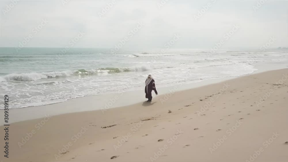 Russian Santa Claus with a bag of gifts walks along the seashore. Russian Santa Claus with a bag of gifts walks along the seashore.