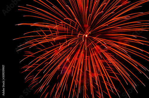 Bright festive fireworks against the night sky. Firework Fiery flowers during the holiday.