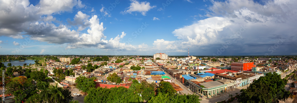 Fototapeta premium Aerial Panoramic view of a small Cuban Town, Ciego de Avila, during a cloudy and sunny day. Located in Central Cuba.