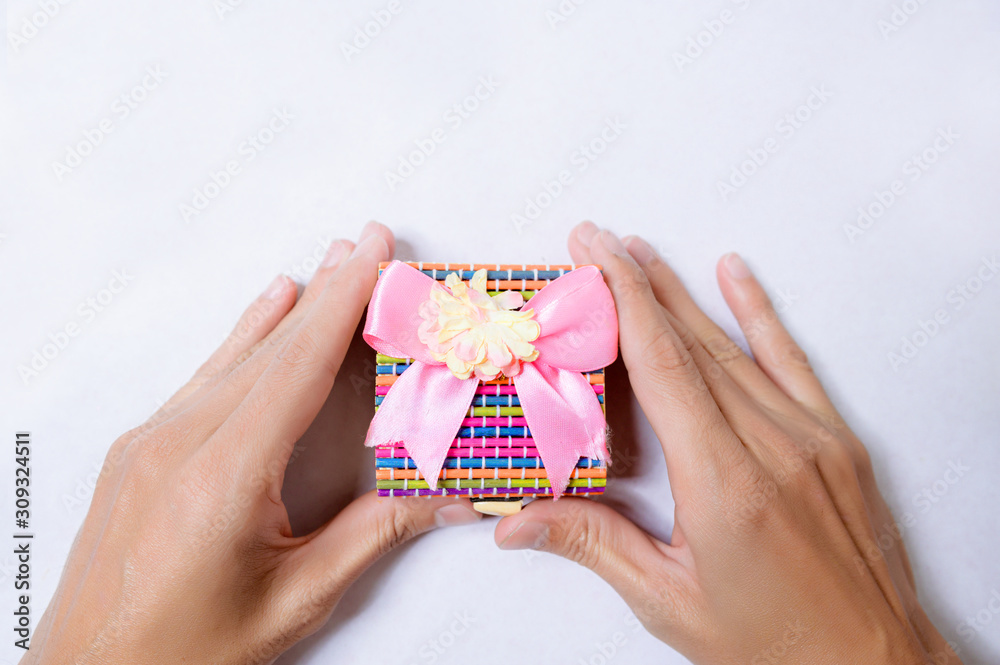Hands holding gift box on white background top view. Hands holding gift box on white background top view.