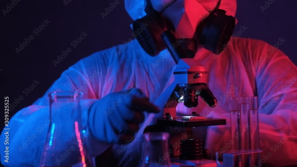 researcher in scientific and technical laboratory with neon light examines computer processor in microscope. Scientific and industrial research under microscope. concept of modern technological future researcher in scientific and technical laboratory with neon light examines computer processor in microscope. Scientific and industrial research under microscope. concept of modern technological future