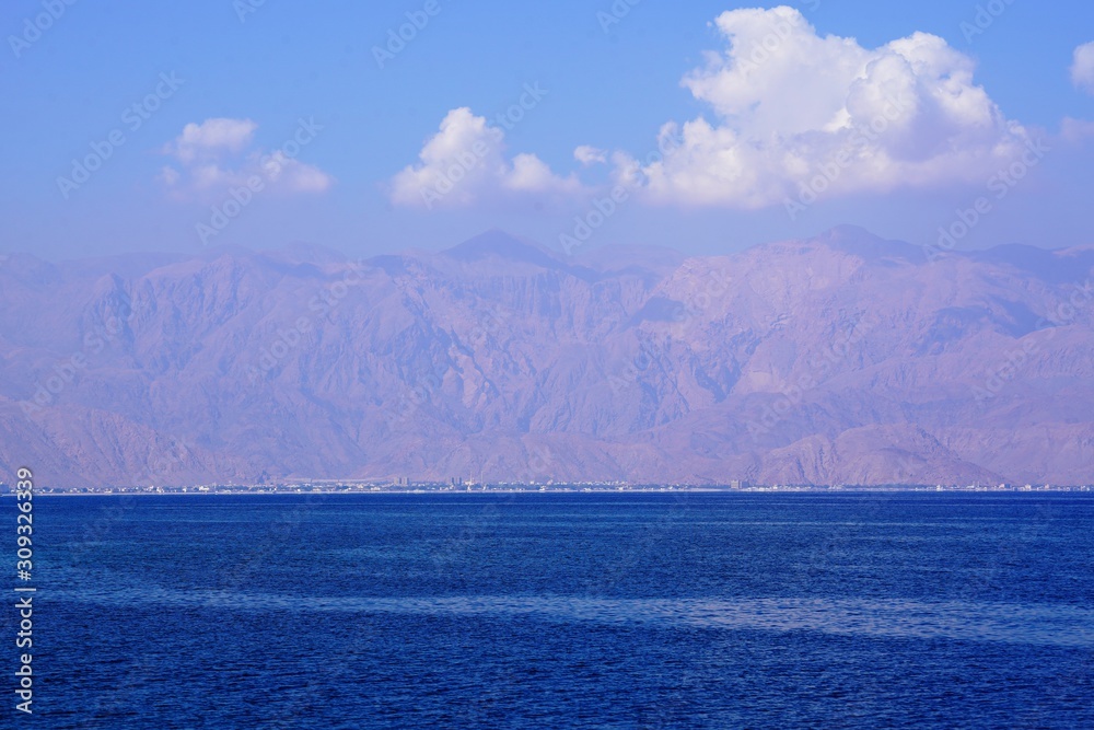 landscape with blue sky and clouds by Hajar mountains