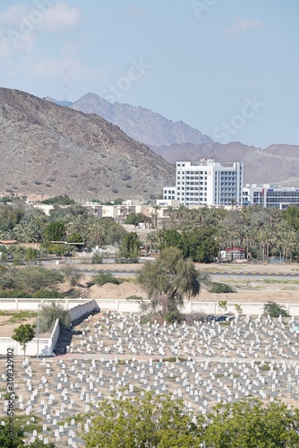 view on old Arabic cemetery by mountains and sky at sunny summer day photo