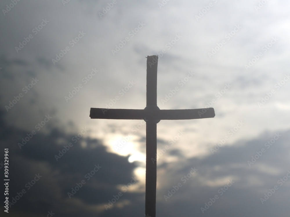 Christian wooden cross on a background with dramatic lighting.Concept for Christian, celestial resurrection or god.Jesus Christ cross.