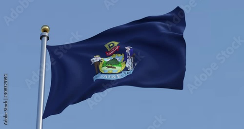 Maine flag blowing in the wind in front of a blue sky
