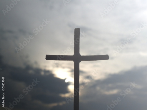 Christian wooden cross on a background with dramatic lighting.Concept for Christian, celestial resurrection or god.Jesus Christ cross.