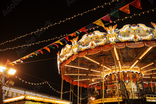 Christmas carousel  on Red square in Moscow, Russia. New year celebration and fairy. Decorated city at sunset. Xmas holiday in Moscow. photo