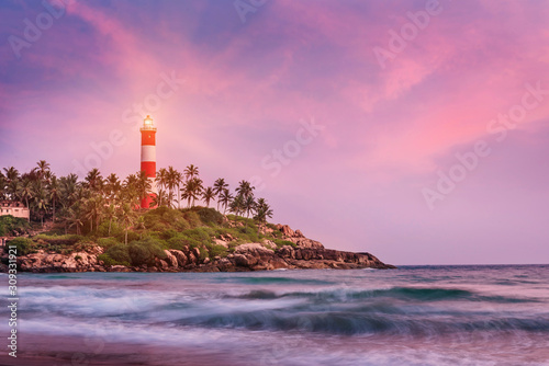 Lighthouse on the cliff in Kovalam Beach photo