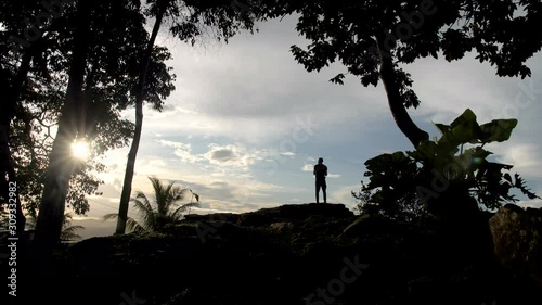 A male silhouette looking to the sunset on the hill steady view photo