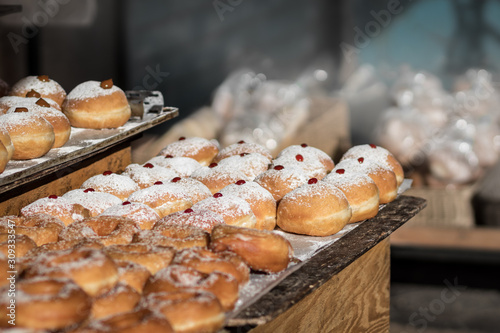 Hanukkah donuts (sufgania) are delicious and sweet in honor of Chanukah (the winter Jewish holiday in memory of miracles and wonders). Filled with strawberry jam or milk jam and deep-fried. photo