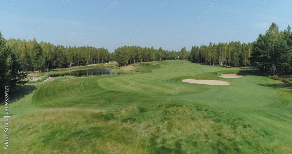 Summer sunny day, aerial view of Golf course in forest area, Golf Club, view of the field of green lawn near the forest. Summer sunny day, aerial view of Golf course in forest area, Golf Club, view of the field of green lawn near the forest.