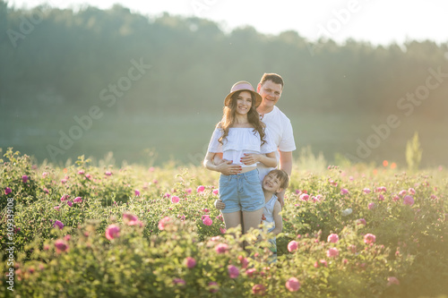 Family couple of togetherness in a field of flowers