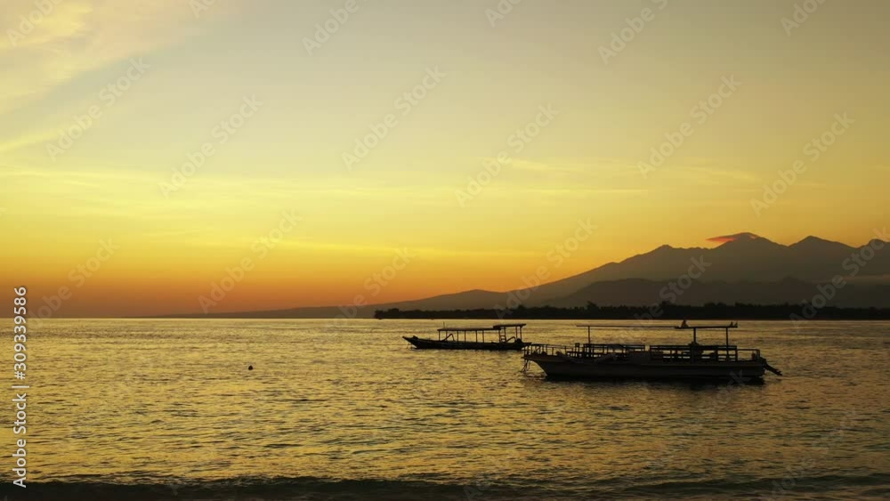 sunset over the beautiful philippine lagoon with small fishing boats in the foreground and mountains in the background sunset over the beautiful philippine lagoon with small fishing boats in the foreground and mountains in the background