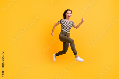 Full size profile side photo of funny sportive girl jump run practice sport jogging on spring holidays free time wear modern outfit isolated over shine color background © deagreez