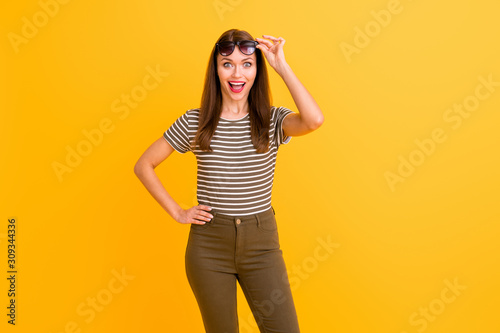 Portrait of impressed funky crazy girl have spring vacation look incredible black friday bargains touch her spectacles wear casual style outfit isolated over bright color background