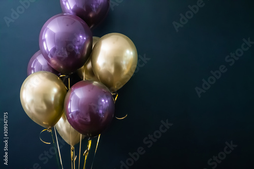 Set of gold and purple balls on a dark background. Holiday concept, postcard