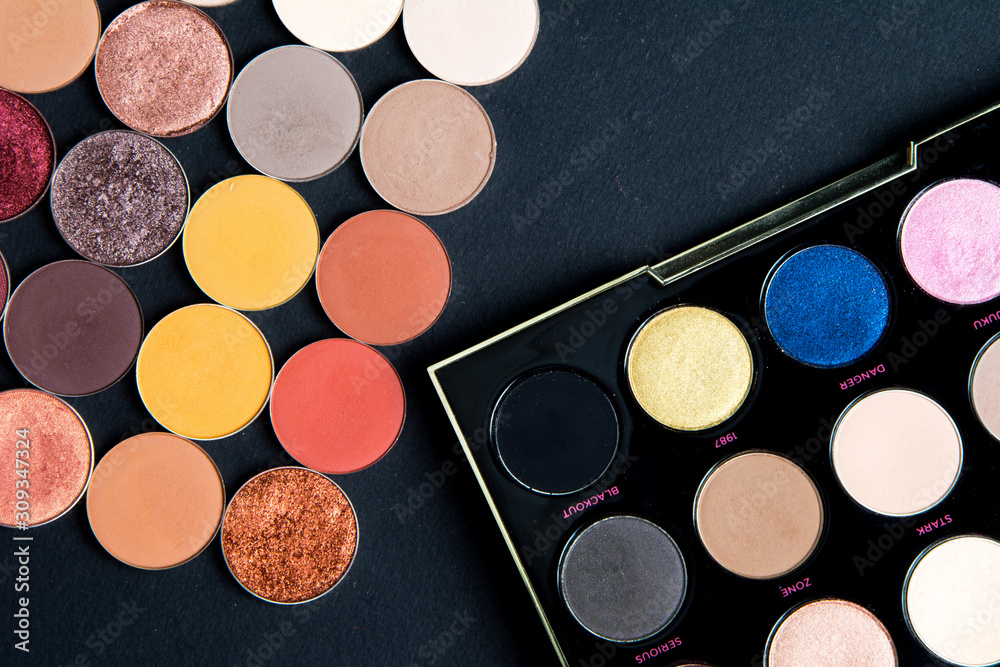 Make-up colorful eye shadow palettes isolated on black background. 