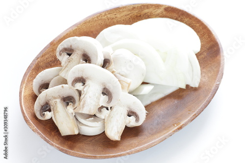 Chopped mushroom and onion on wooden plate