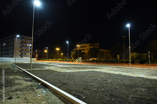 Night Park in the City Illuminated by Lamps with Buildings Near
