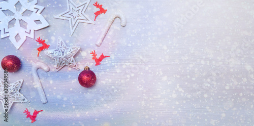 Red-White Christmas card with stars, baubles, reindeer and sugar canes.