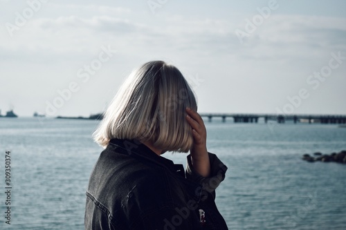 young woman with white hair on the beach