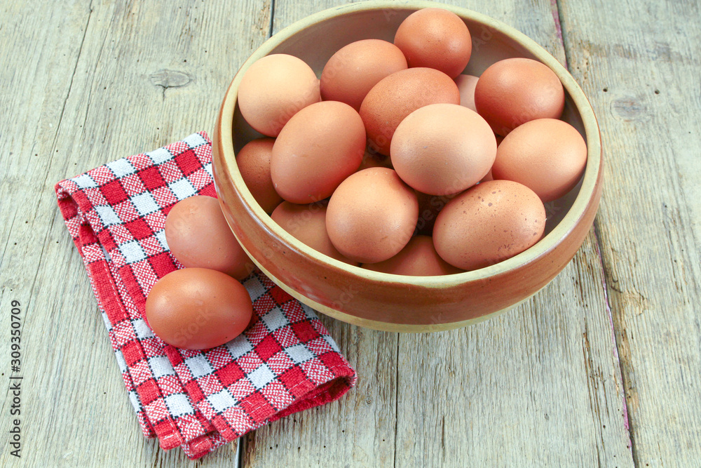 dish filled with raw eggs on a wooden table