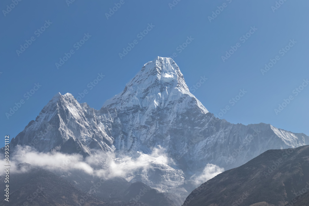 Ama Dablam is a mountain in the Himalaya range of eastern Nepal. The main peak is 6,812 metres, the lower western peak is 6,170 metres