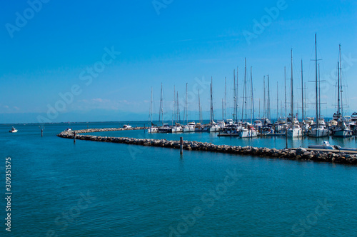 Dock with yachts on a background of blue sea