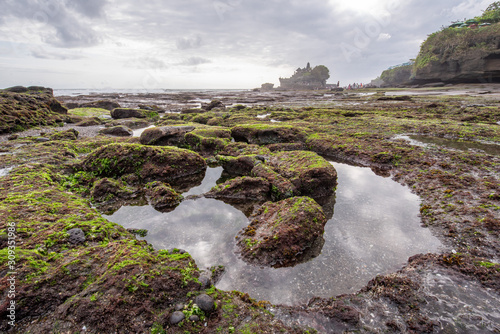 Scenic landscape of Tanah Lot water temple in Bali during sunset. Tanah Lot is one of Bali's most important landmarks for tourists in Bali,Indonesia.